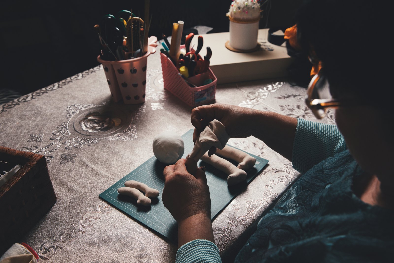 Hands working with natural materials at a craft station